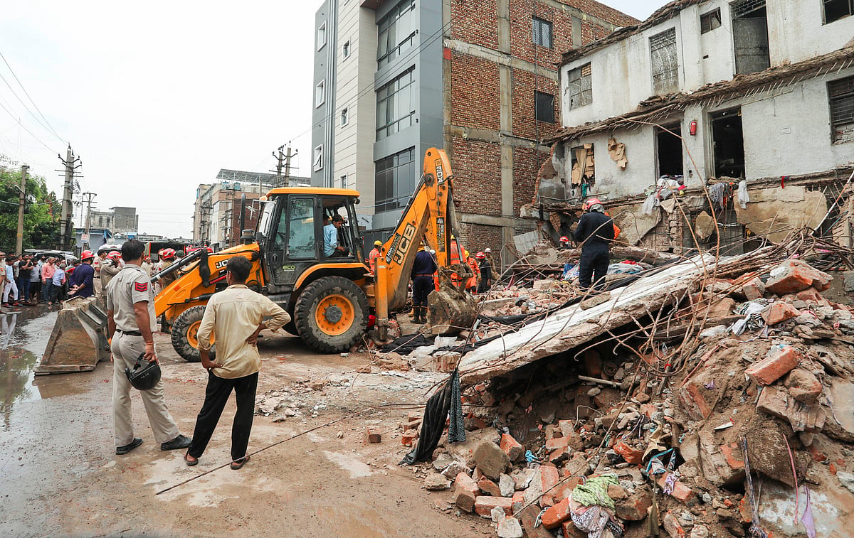 PTI : Officials and others during a rescue operation after a portion of a two-storey building collapsed at Jahangirpuri area, in New Delhi, Friday, Aug. 2, 2024
